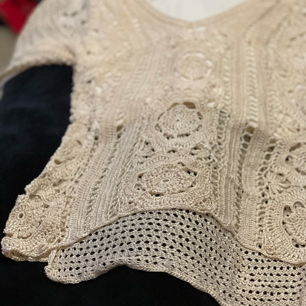 Crochet top with underlying tank.
